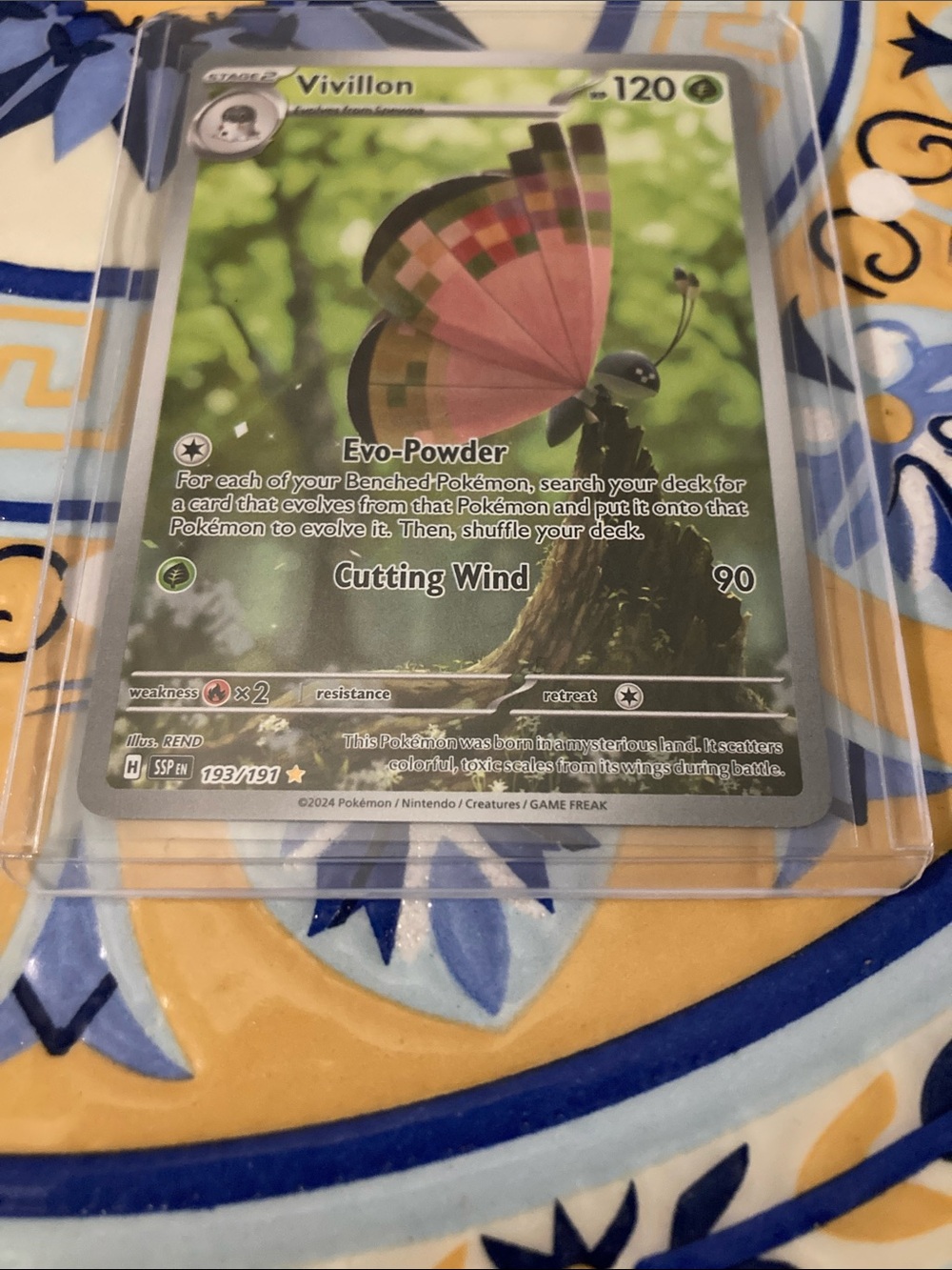 Pokemon Vivillon Card with Pink Wings and Green Background